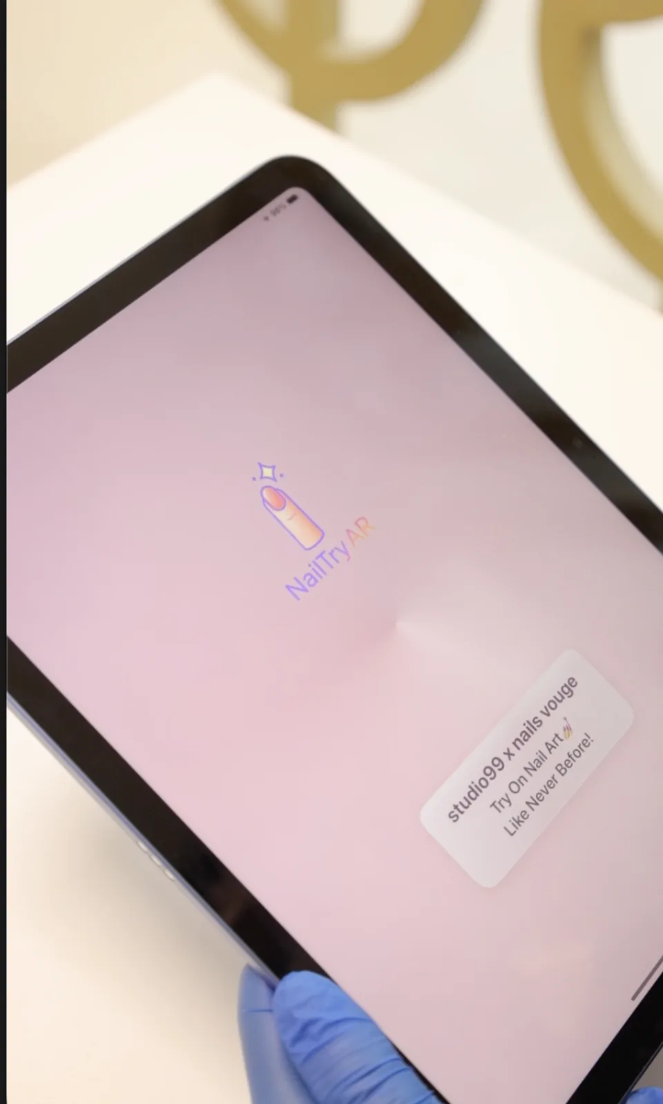 The salon’s pink branded welcome screen displayed on an iPad.
