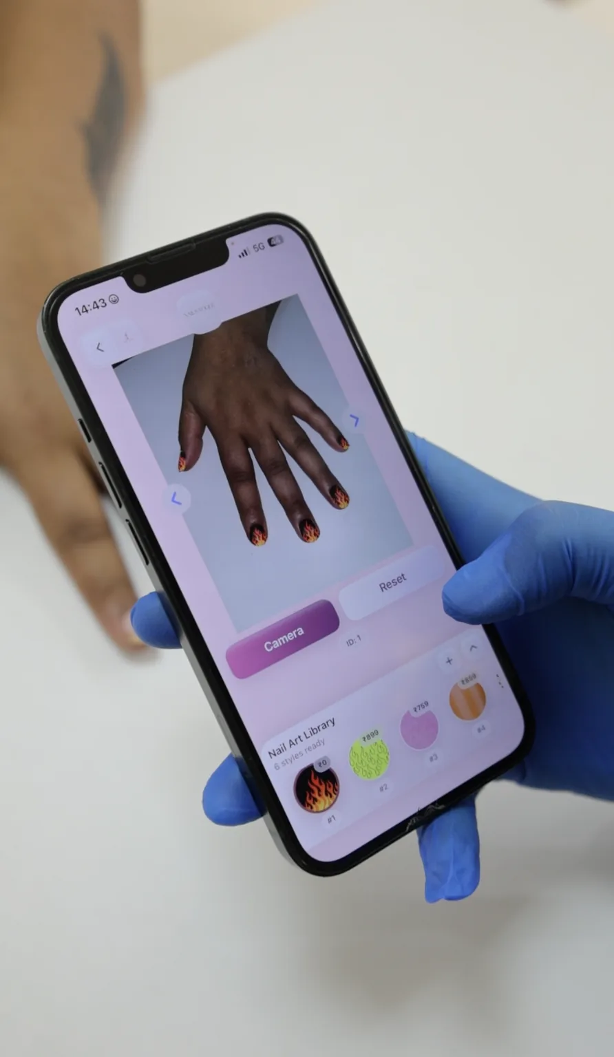 A phone shows the client’s hand above the nail colour selection controls.