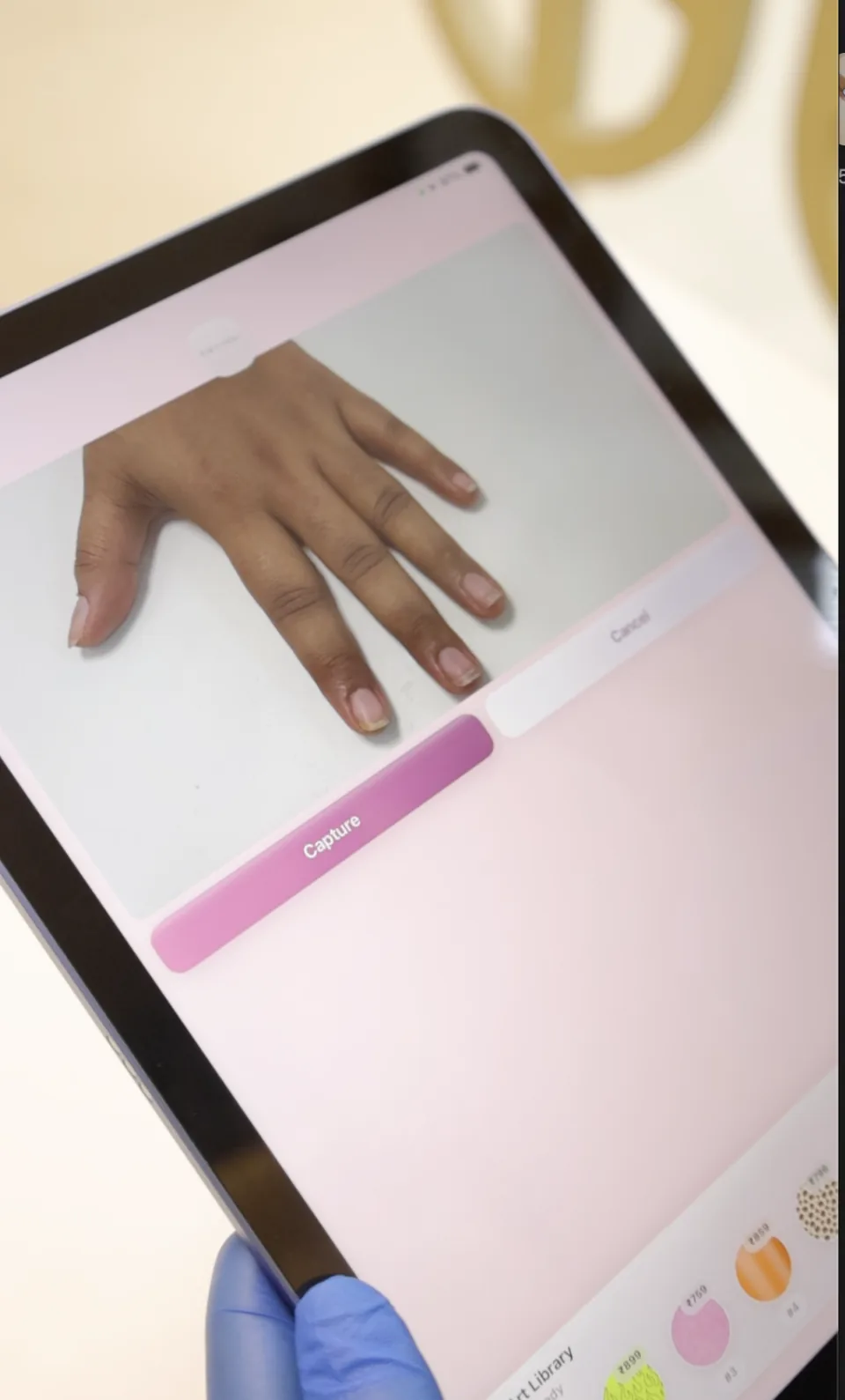 An iPad displays the client’s hand and nail art library during a consultation.