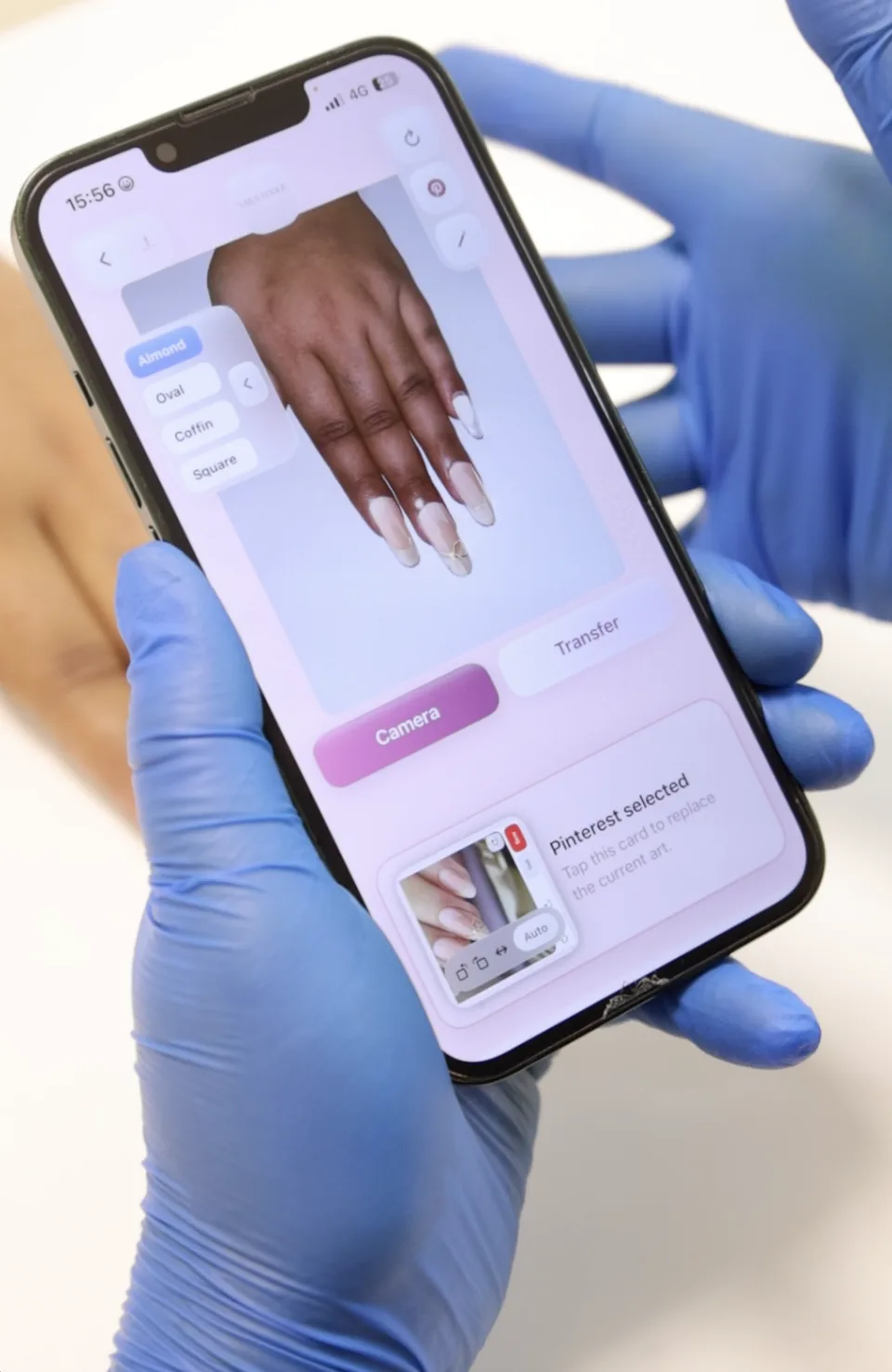 Reference nail art appears beneath the client’s hand preview on a phone.